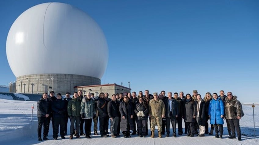 Chief of Space Operations U.S. Space Force Gen. Chance Saltzman and distinguished guests stand in front of a radar dome belonging to the 23rd Space Operations Squadron Detachment 1 at Pituffik Space Base, Greenland, on April 5, 2023.