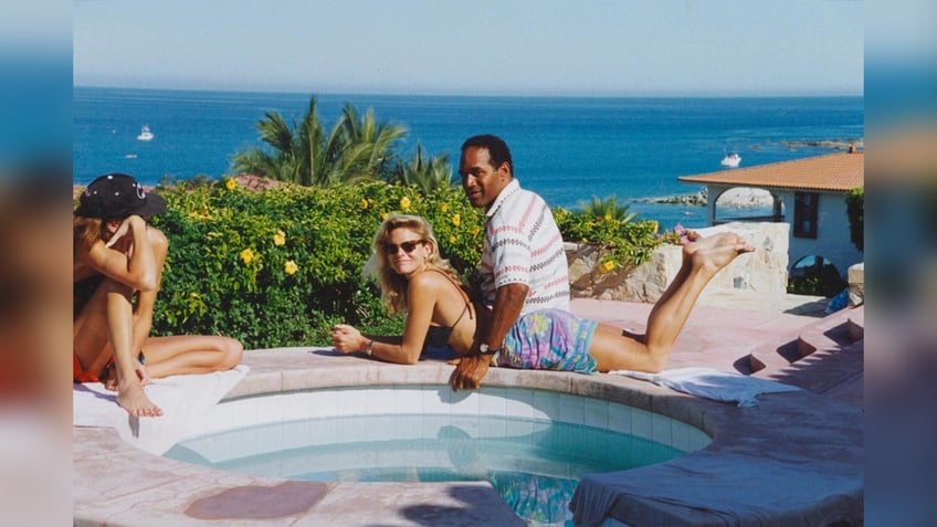 Nicole Brown Simpson and OJ Simpson at poolside