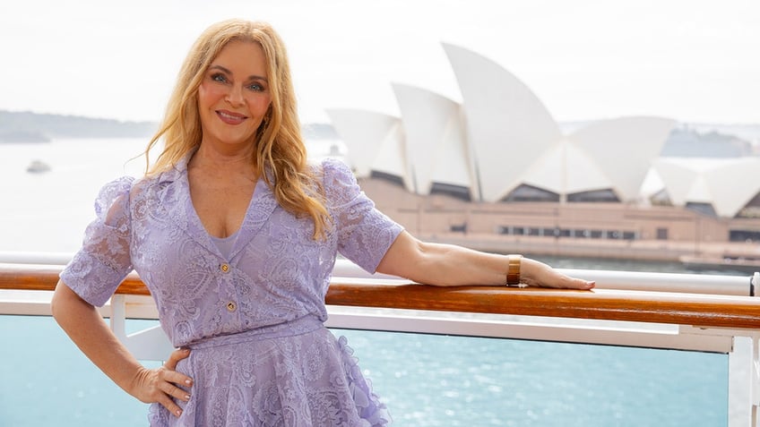 A close-up of Jill Whelan wearing a purple lace dress on a cruise ship in Australia