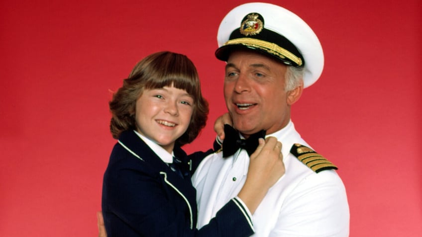 A close-up of Jill Whelan fixing Gavin MacLeods bow tie in "The Love Boat"