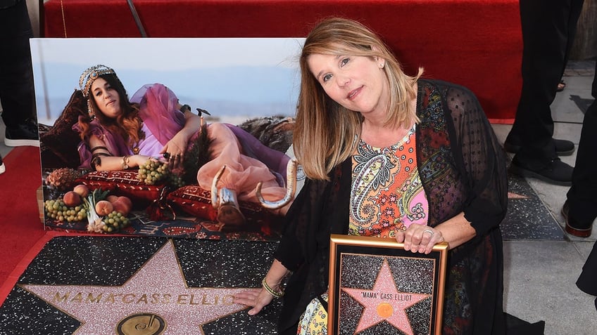 Owen Elliot-Kugell posing next to her mother's star on the Hollywood Walk of Fame