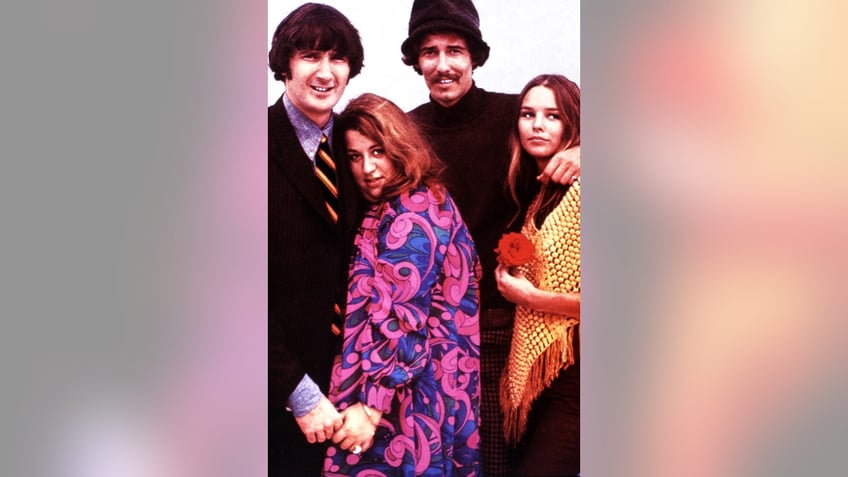 A colored photo of the Mamas and the Papas wearing 60s fashion