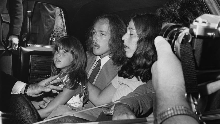 Owen Elliot-Kugell sitting inside a car with a group of people