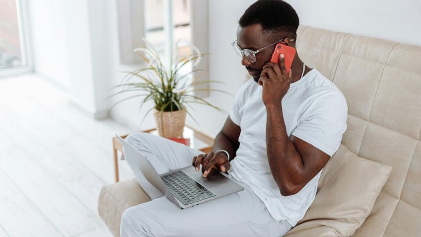 seated man with phone