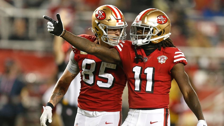 George Kittle celebrates with Brandon Aiyuk