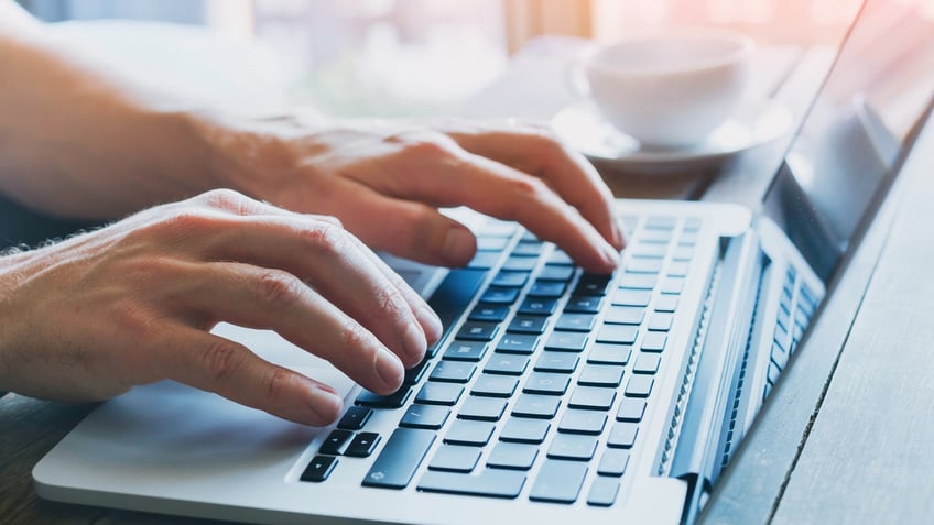 close up of hands of business person working on computer, man using internet and social media