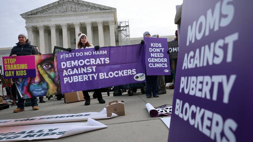 Transgender rights opponents rally outside the U.S. Supreme Court as the justices hear arguments in a case on transgender health rights on Dec. 4, 2024 in Washington, D.C.