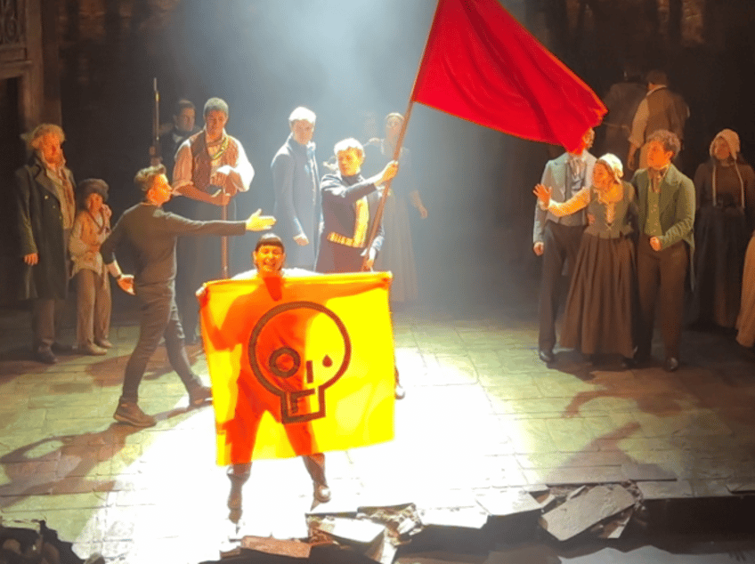 the show wont go on les miserables cancelled as green activists storm theatre attach themselves to set