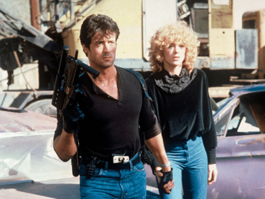 American actor Sylvester Stallone holding by her hand Danish actress Brigitte Nielsen in t
