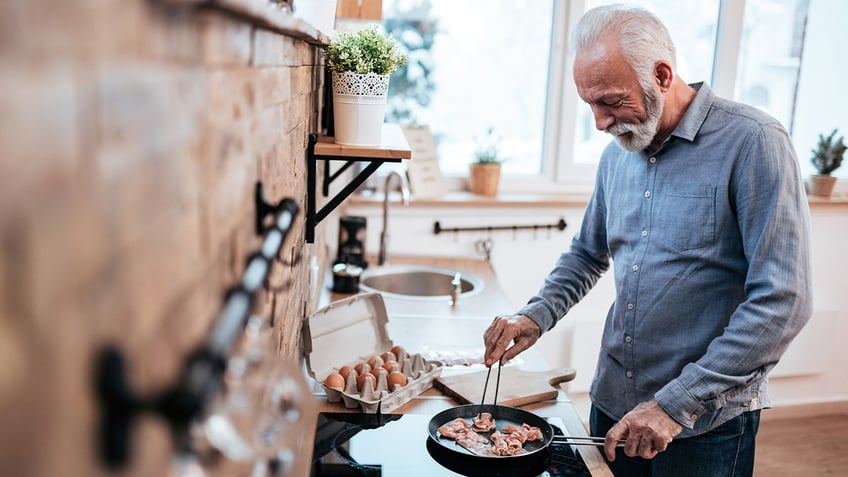 man making bacon for breakfast