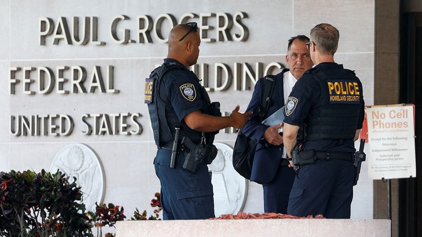 Police officers stand outside the Paul G Rogers Federal Building U.S. Courthouse