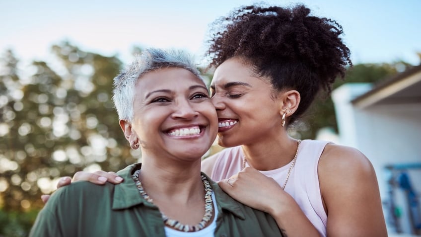 Mom and daughter smiling