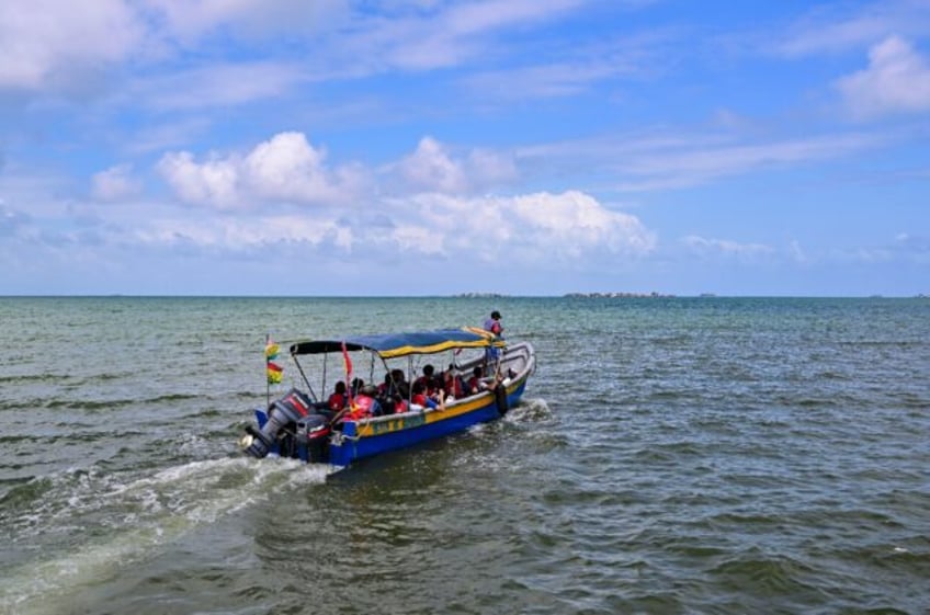 Migrants who have abandoned their hopes of reaching the United States take a boat in Panam