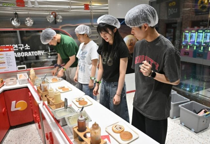 Visitors role play as researchers in a mock burger laboratory at an adults-only event at K