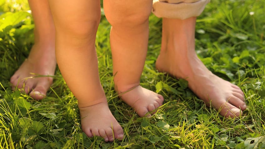 baby walking in spring grass 