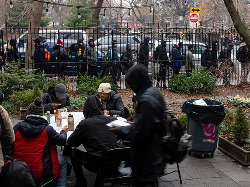 People, mostly newly arrived migrants, receive an afternoon meal from Trinity Services and