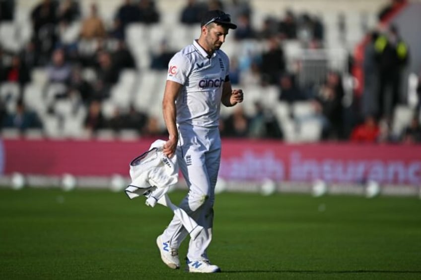 Sidelined: England fast bowler Mark Wood leaves the field after suffering a thigh injury i