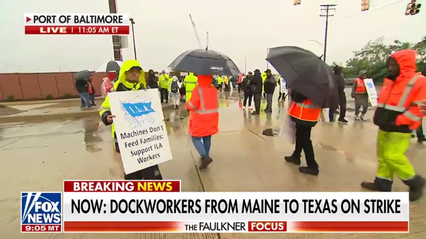 Striking longshoremen walk in the rain at the Port of Baltimore as both sides jockey for position in negotiations.