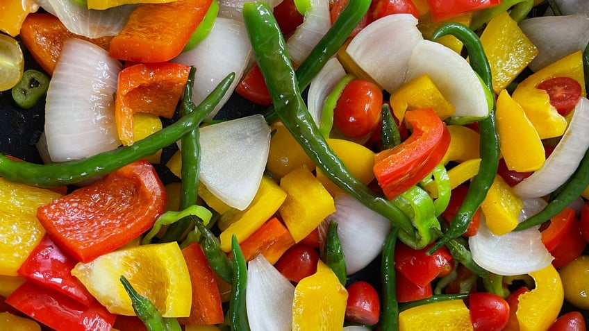 This is a close-up look at the different vegetables that make up the colors of the rainbow in a veggie stir-fry dish.