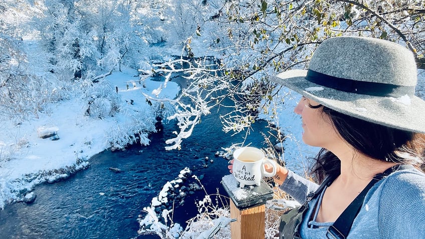 Taralyn Romero looking over snowy creek