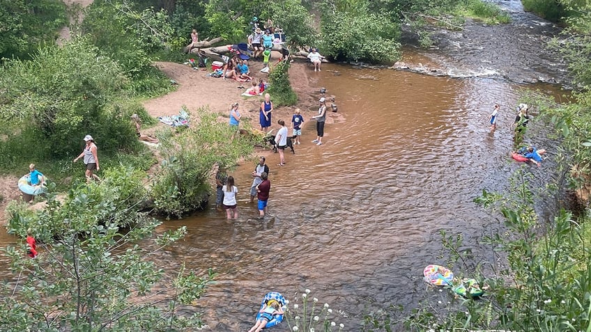 Families recreating in Bear Creek on a sunny day