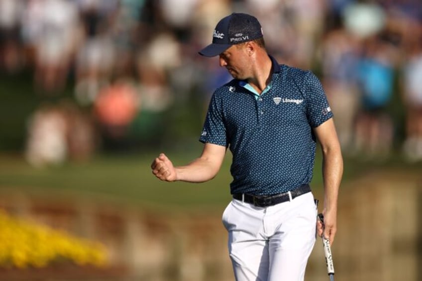 American Justin Thomas, pumping his fist after a birdie at 17, matched the course record w