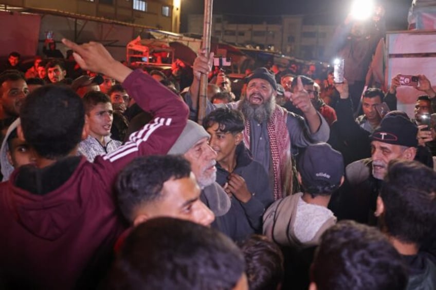 Gazans celebrate along a street in Khan Yunis after news spread of a ceasefire agreement b