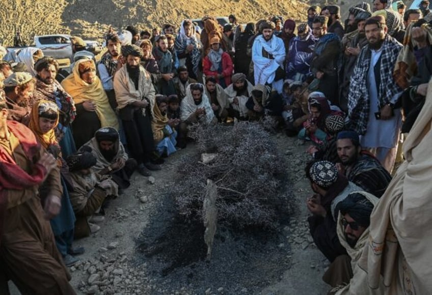 Afghan men offered prayers around the grave of Khalil Ur-Rahman Haqqani, the Minister for