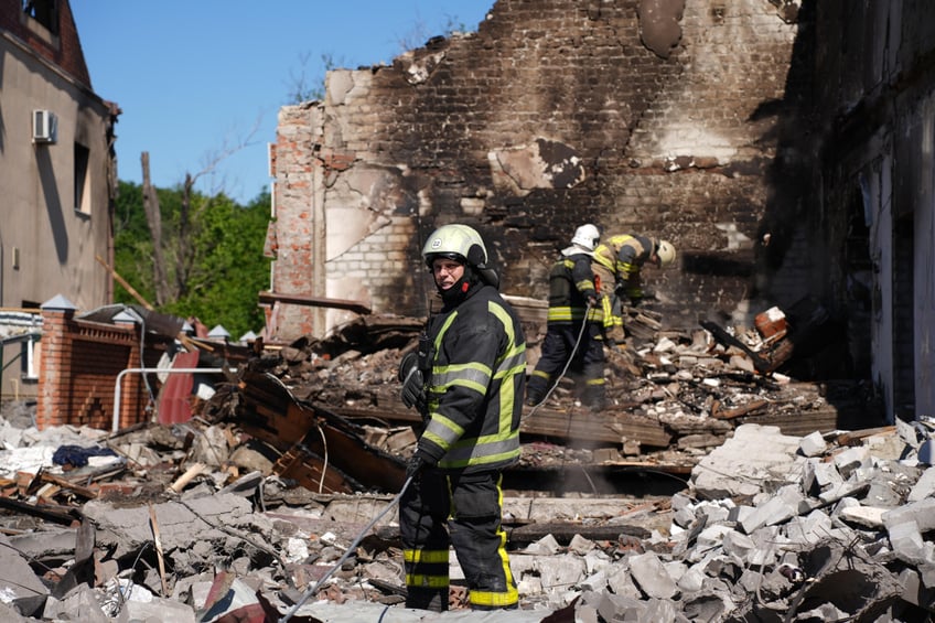 KHARKIV, UKRAINE – MAY 10: Rescuers respond at the site of a Russian missile strike on the city's private residential buildings area on May 10, 2024 in Kharkiv, Ukraine. In the early morning, the Russian army launched a missile attack on Kharkiv, hitting an area of private residential buildings and leaving two persons injured, including one child. Three private residential buildings were destroyed by a strike and fire, another 12 were damaged by a missile's fragments. Rescuers stopped extinguishing the fire three times due to the threat of the double tap-strikes, and the air-raid siren lasted more than six hours in the city and oblast. (Photo by Eugene Hertnier/Suspilne Ukraine/JSC "UA:PBC"/Global Images Ukraine via Getty Images)