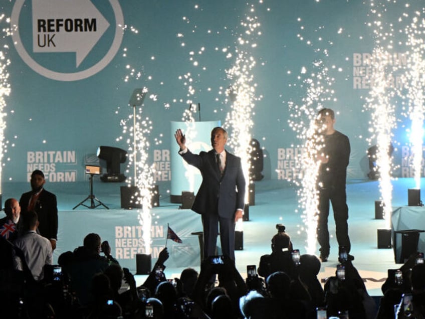 Pyrotechnics go off as Reform UK leader Nigel Farage arrives to deliver a speech during th