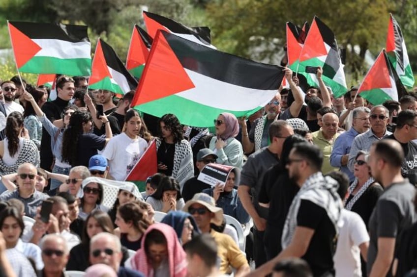 Arab citizens of Israel wave Palestinian flags as they demonstrate for an end to the Gaza