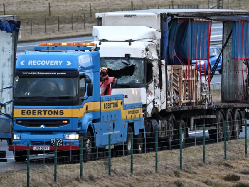 Two lorries blown over on the M6 motorway during the high winds of Storm Isha, are recovered near Shap, north west England on January 22, 2024. Tens of thousands of people across the UK and Ireland were without power on Monday after Storm Isha lashed the countries with strong winds …