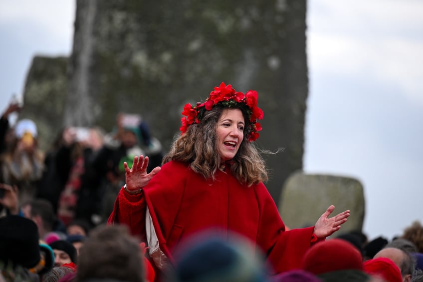 WILTSHIRE, ENGLAND - DECEMBER 21: Visitors celebrate the Winter Solstice at Stonehenge on December 21, 2024 in Wiltshire, England. The winter solstice, which occurs around December 21st each year, marks the shortest day and longest night of the year. (Photo by Finnbarr Webster/Getty Images)