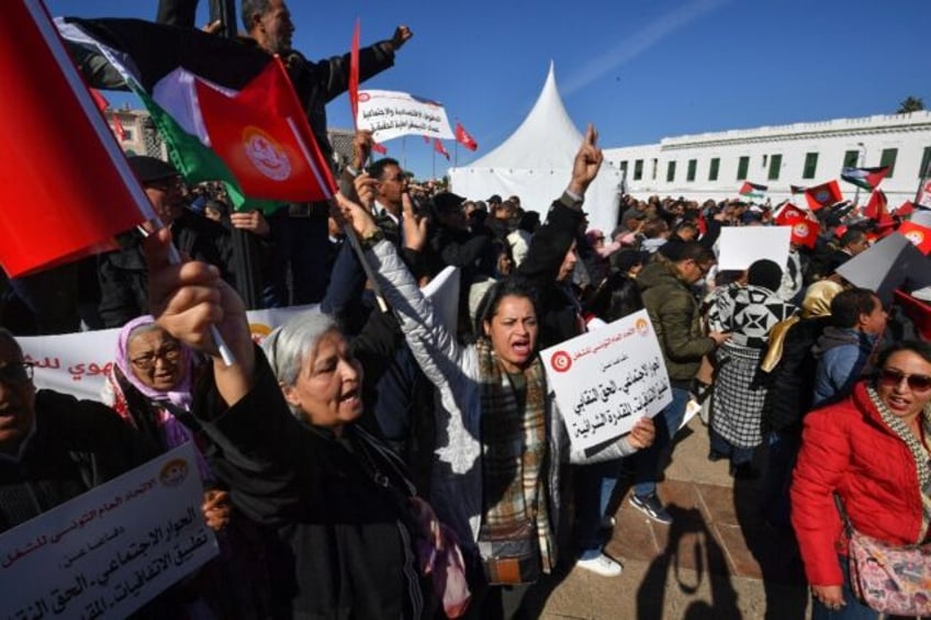 Thousands of trade unionists protest outside the prime minister's office in Tunis against