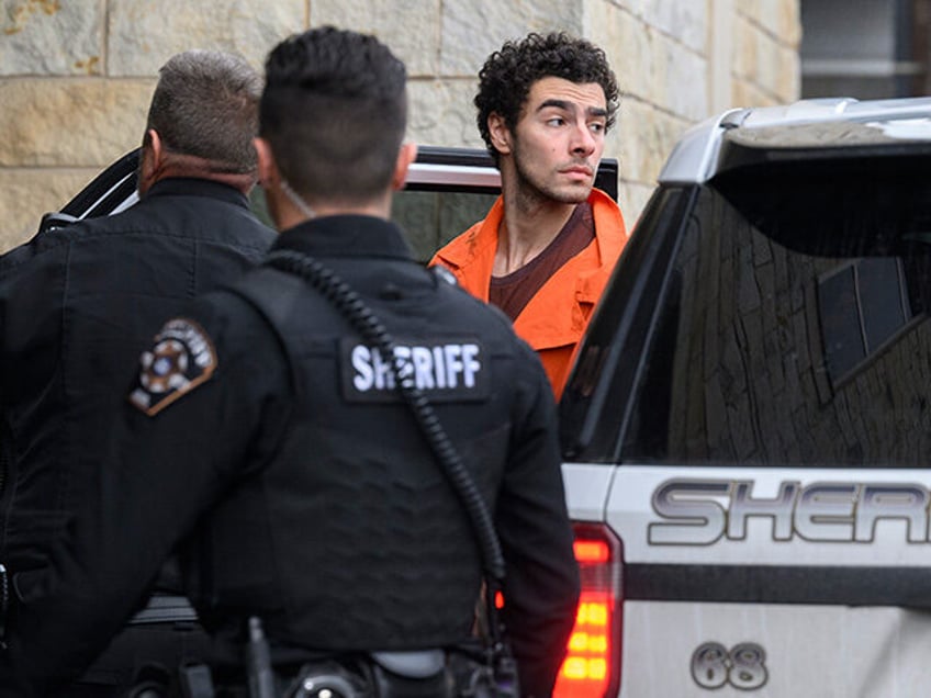 Suspected shooter Luigi Mangione is led into the Blair County Courthouse for an extraditio