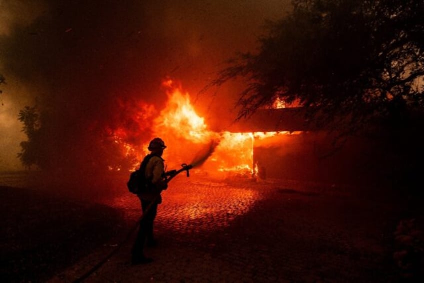 A fast-moving fire near Los Angeles has forced thousands from their homes and destroyed do