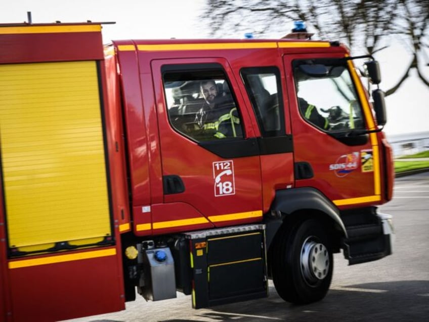 A firefighter looks out the window of a fire truck in Saint-Nazaire, western France, on Ja