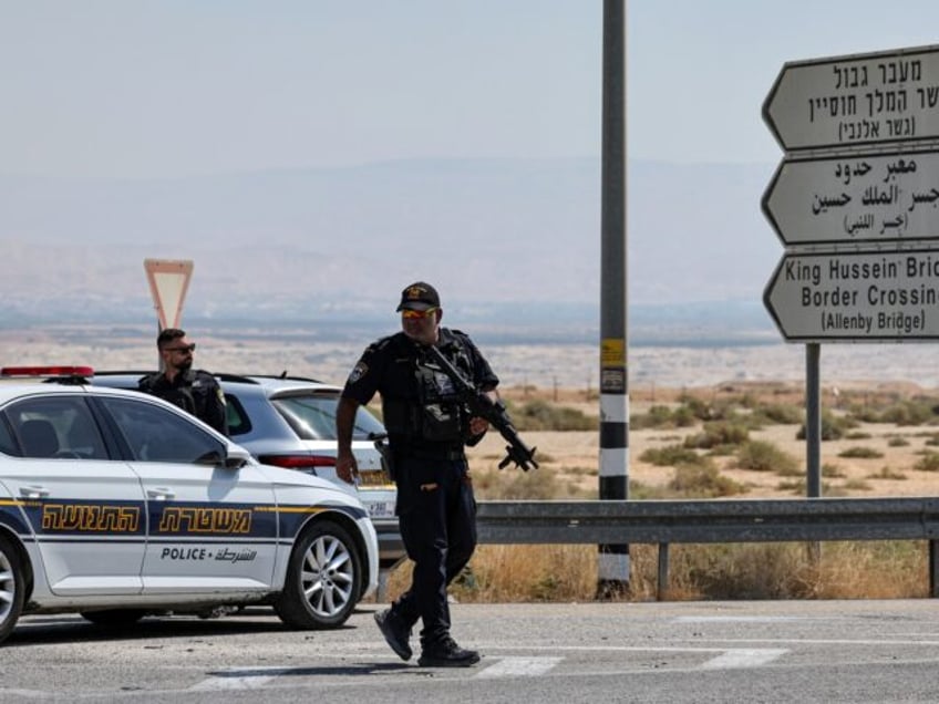 Israeli security forces gather at the scene of a reported attack near the Allenby Crossing