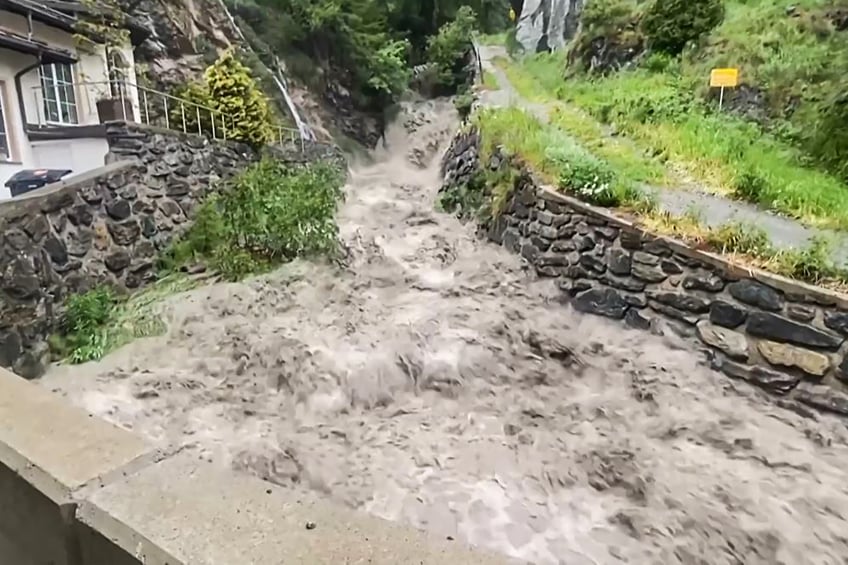 This grab made from an AFP video on June 22, 2024 shows the Visp River in flood in Zermatt on June 21, 2024. The violent storms that have battered the region in recent days, coupled with the melting snow - abundant this year - have caused flooding in the picturesque village of Zermatt at the foot of the Matterhorn, where the river Visp has violently burst its banks. (Photo by KEYSTONE / AFP) / Switzerland OUT