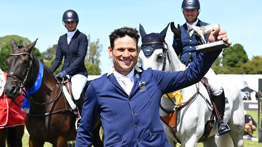 Shane Rose holds an award