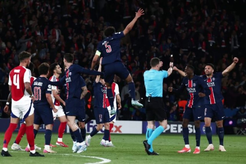 Paris Saint-Germain players celebrate as the referee blows the final whistle in the Champi