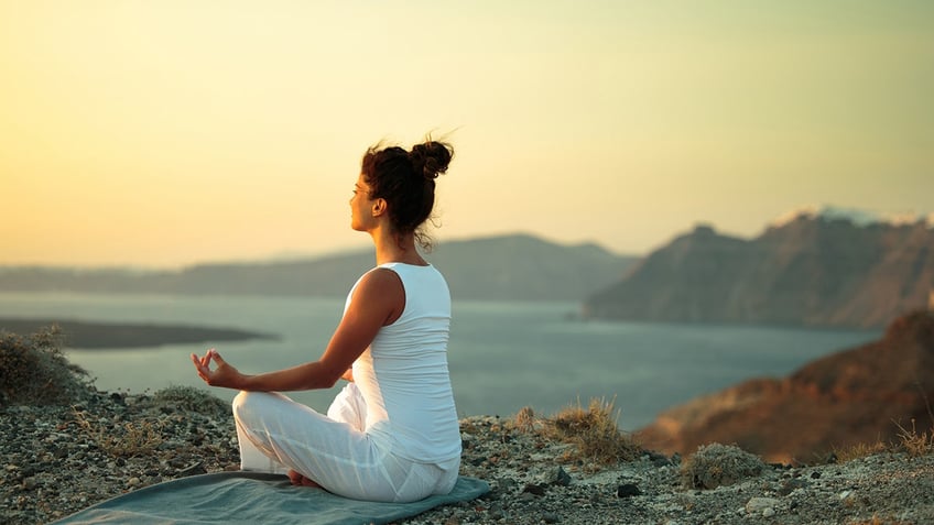 woman seeking stillness on the beach