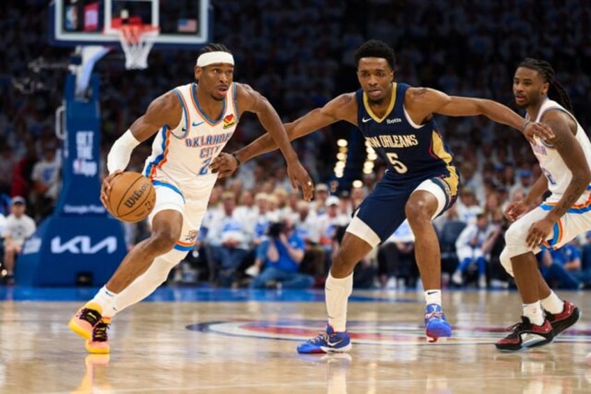 Shai Gilgeous-Alexander of the Oklahoma City Thunder brings the ball up court in the Thund