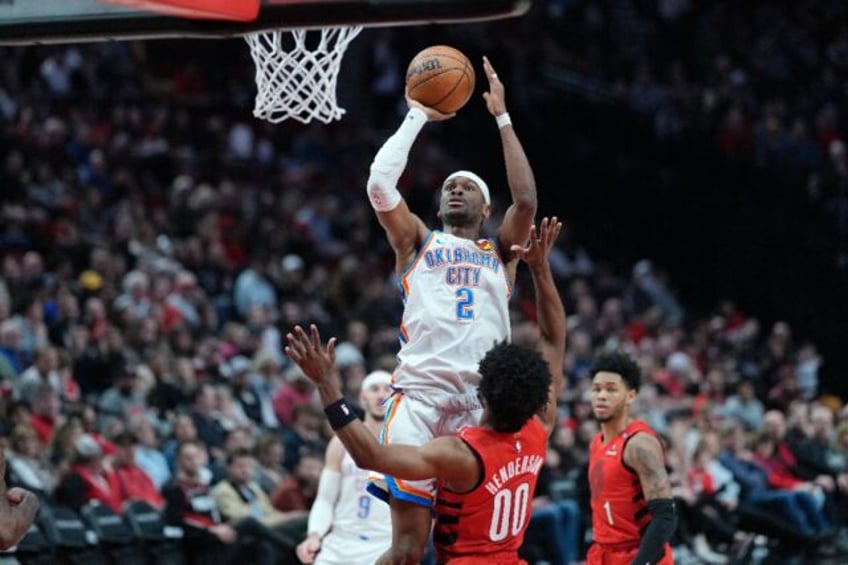 Oklahoma City's Shai Gilgeous-Alexander rises for a shot over Scoot Henderson in the Thund