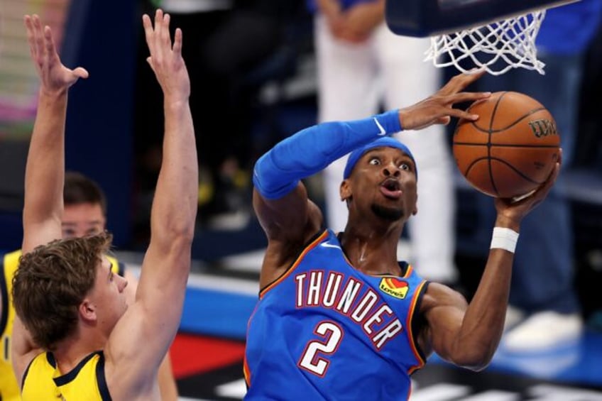 Shai Gilgeous-Alexander of the Oklahoma City Thunder attempts a layup in the Thunder's vic