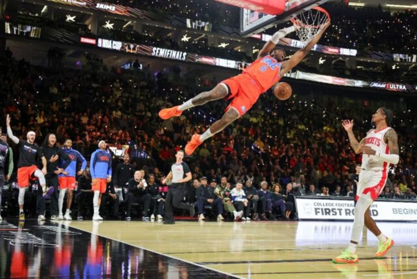 Jalen Williams of the Oklahoma City Thunder dunks over Jalen Green of the Houston Rockets