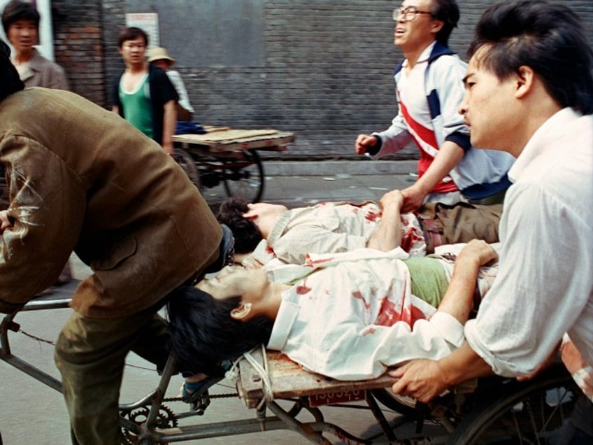 FILE - In this June 4, 1989 file photo, a rickshaw driver peddles wounded people, with the help of bystanders, to a nearby hospital in Beijing after they were injured during clashes with Chinese soldiers in Tiananmen Square. The crackdown ended a period of relative political openness, led to the downfall of Communist Party leader Zhao Ziyang and plunged Beijing into diplomatic isolation that lasted until the late 1990s. (AP Photo/Liu Heung Shing, File)