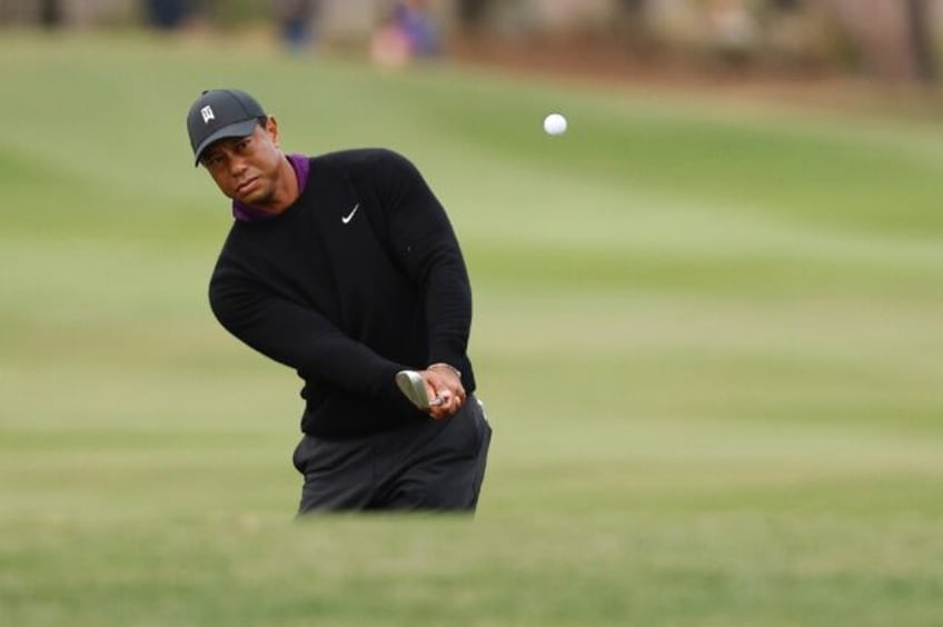 Tiger Woods plays a shot on the 18th hole during a pro-am ahead of playing the weekend's PNC Championship alongside teen son Charlie