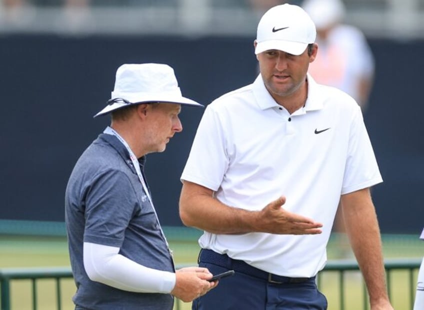 Top-ranked Scottie Scheffler, right, talks with putting coach Phil Kenyon after his final