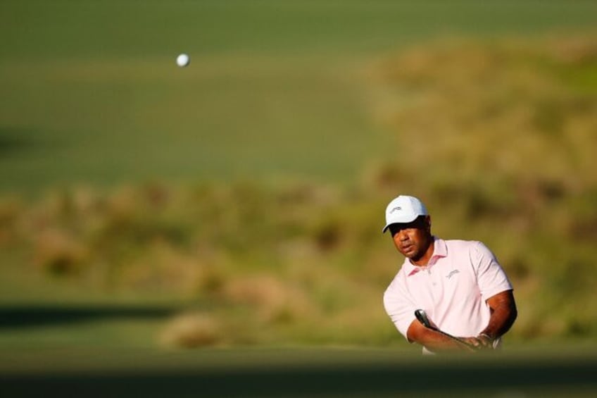 Tiger Woods, chiping onto the first green during a US Open practice round, says merger tal